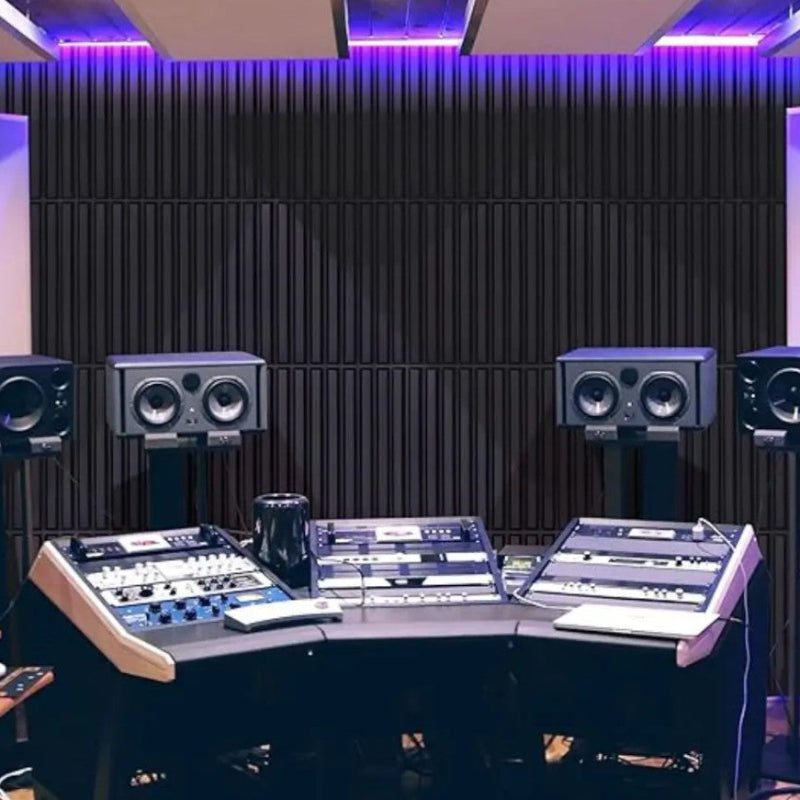 Control room with audio mixing console and speakers in a studio setting
