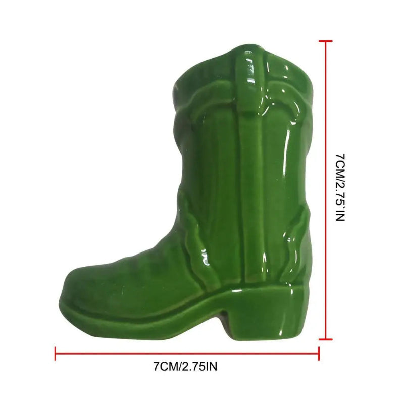 Green ceramic cowboy boot with measurements on a white background