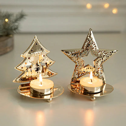 Two gold-colored metal tea light holders, one shaped like a Christmas tree and the other a star, both with lit candles.