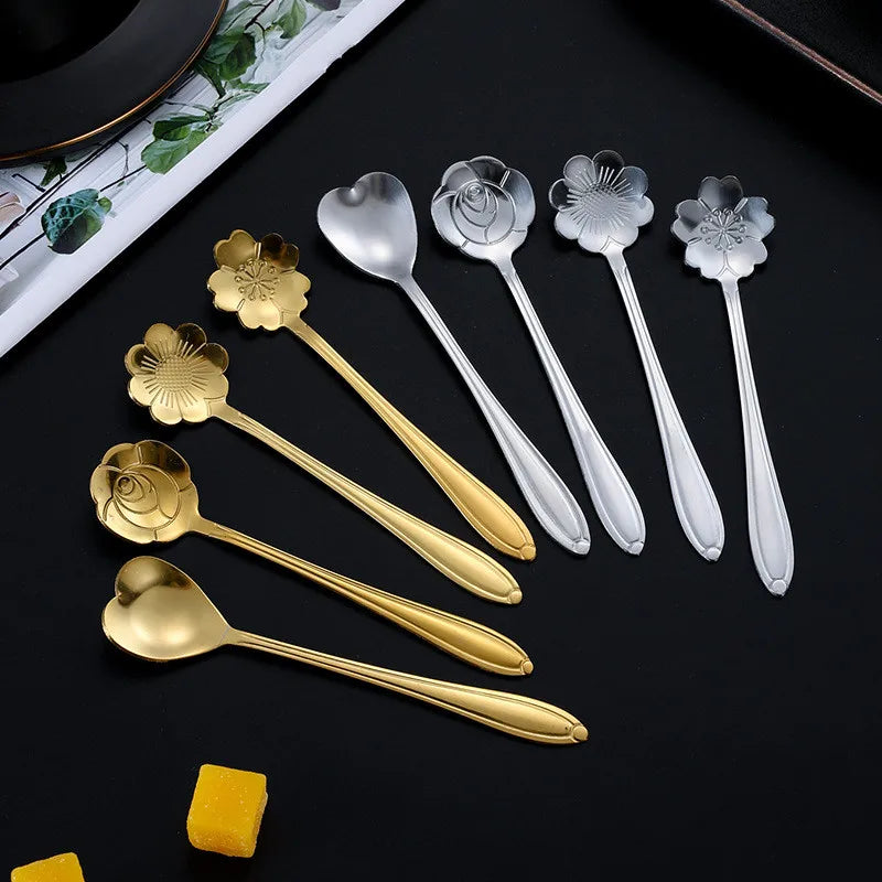 Gold and silver spoons with flower-shaped heads.
