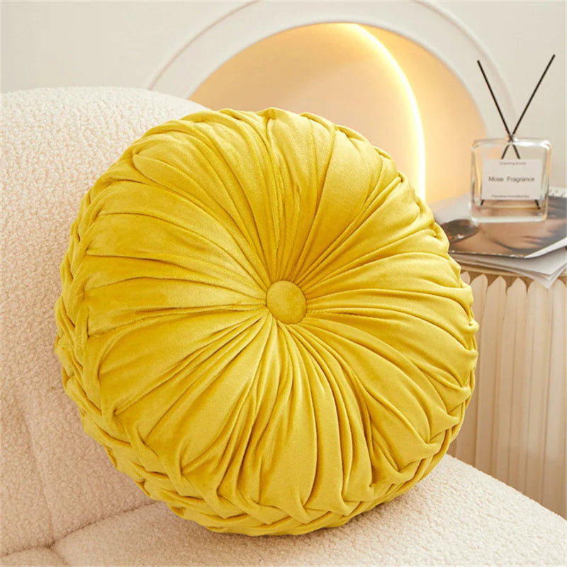 Yellow round pillow on a sofa with a blurred background