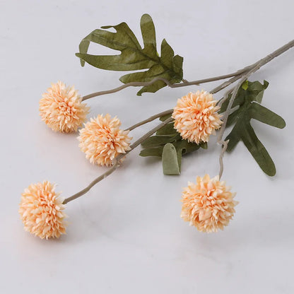 Peach-colored faux flower stem with five spherical blooms.
