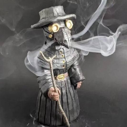 A statuette of a plague doctor in a black coat and hat, holding a staff, with smoke swirling around them.