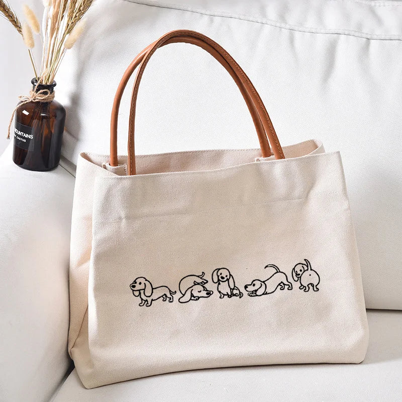 Canvas tote bag with cute dog outlines.