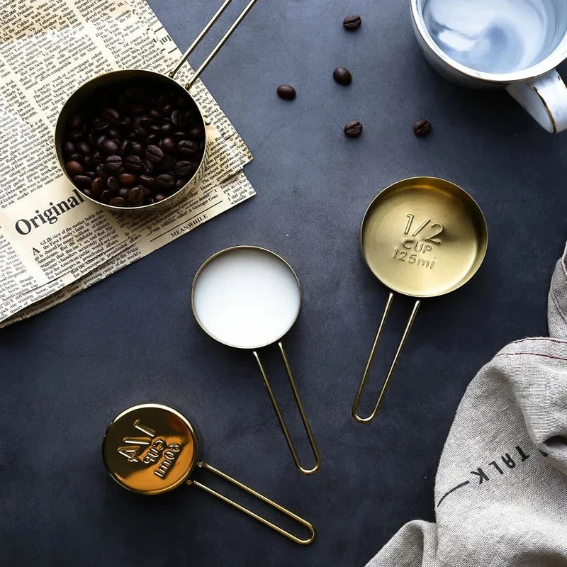 4 gold-colored measuring cups 