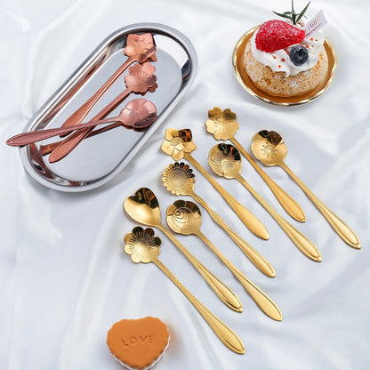 Golden and rose gold flower spoons with a cake and a heart cookie.