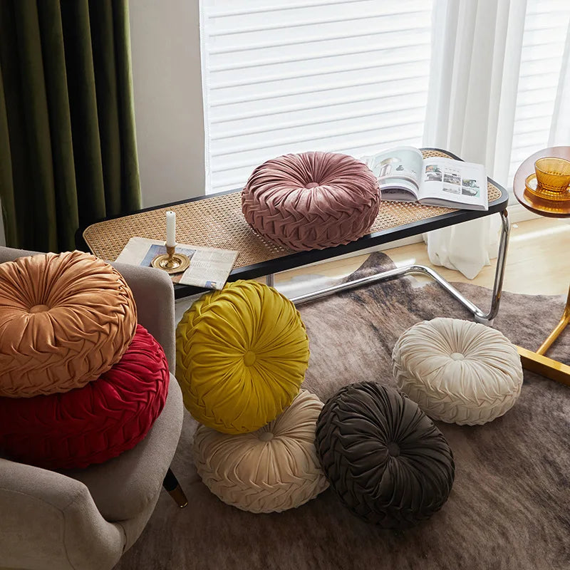 Colorful round pillows on a chair in a living room setting.