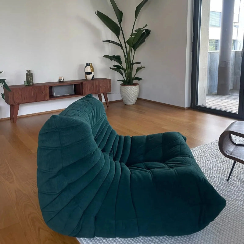 Green modern lounge chair in a living room.