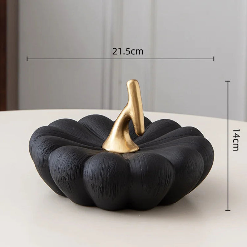 A black decorative pumpkin with a gold stem, measuring 21.5cm wide and 14cm high.