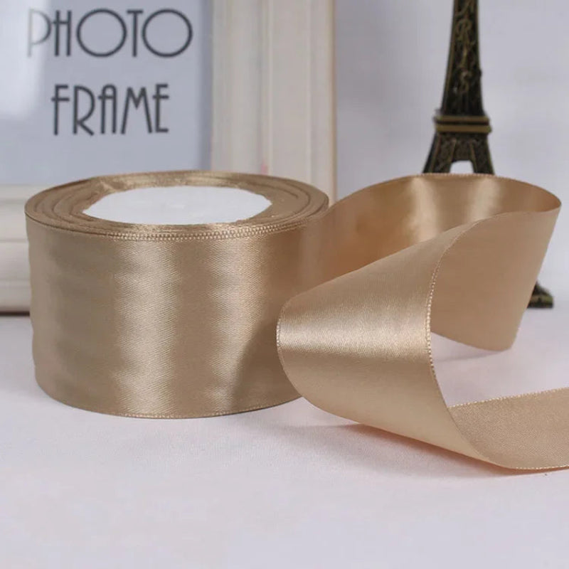 Gold satin ribbon with a photo frame and Eiffel Tower decoration in the background