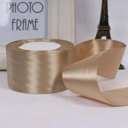 Gold satin ribbon with a photo frame and Eiffel Tower decoration in the background