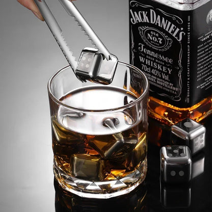 Jack Daniel's whiskey bottle with a glass of whiskey and ice cubes on a gray background