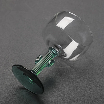 Glass decanter with green stopper on a gray background