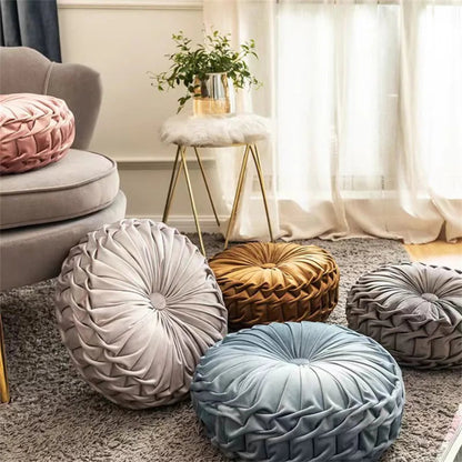 Decorative round pillows in various colors on a carpeted floor with a soft focus background.