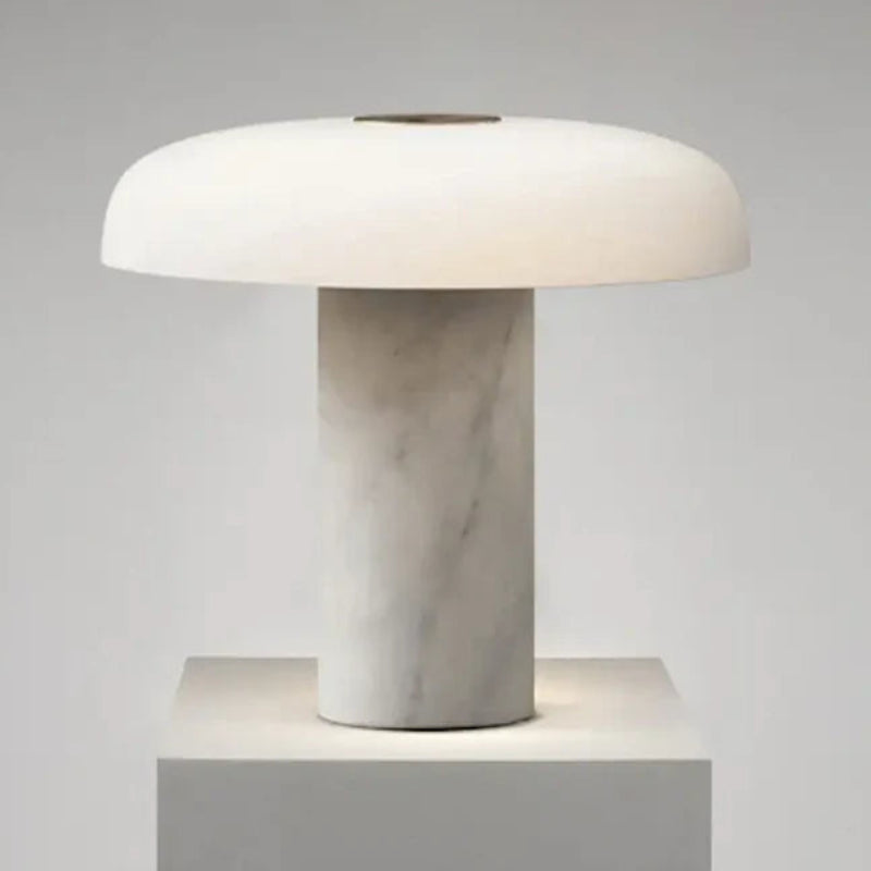 Table lamp with marble base and white shade on a gray background