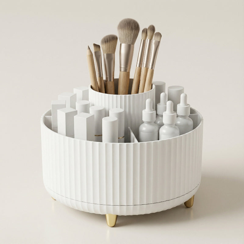 White rotating makeup organizer with makeup brushes and cosmetics on a vanity.