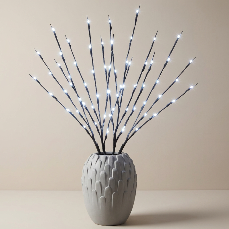 Decorative LED branch arrangement in a textured gray vase on a beige background