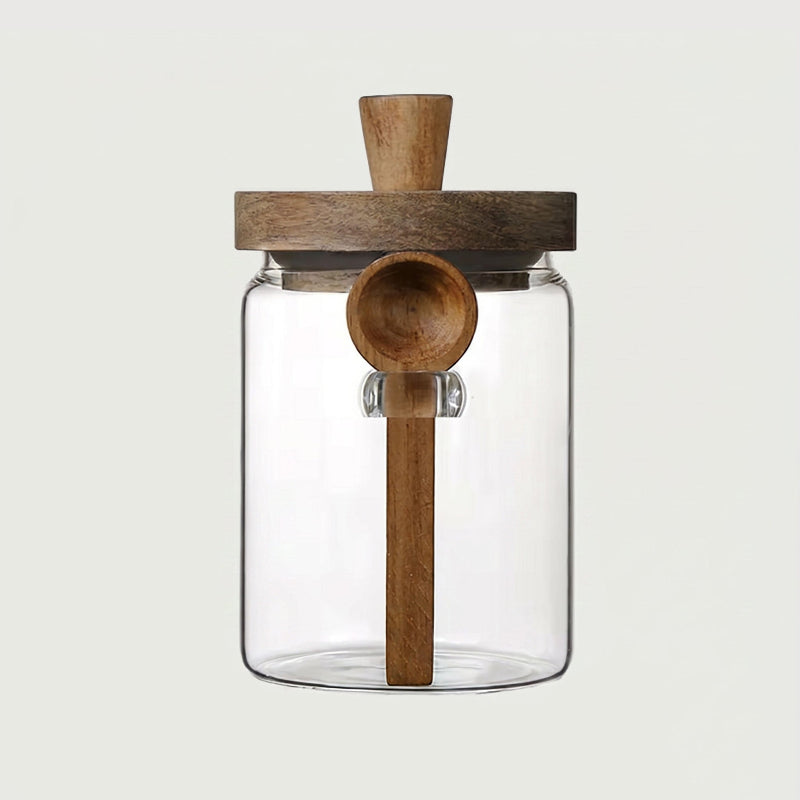 Airtight glass jar with acacia lid and spoon on white background
