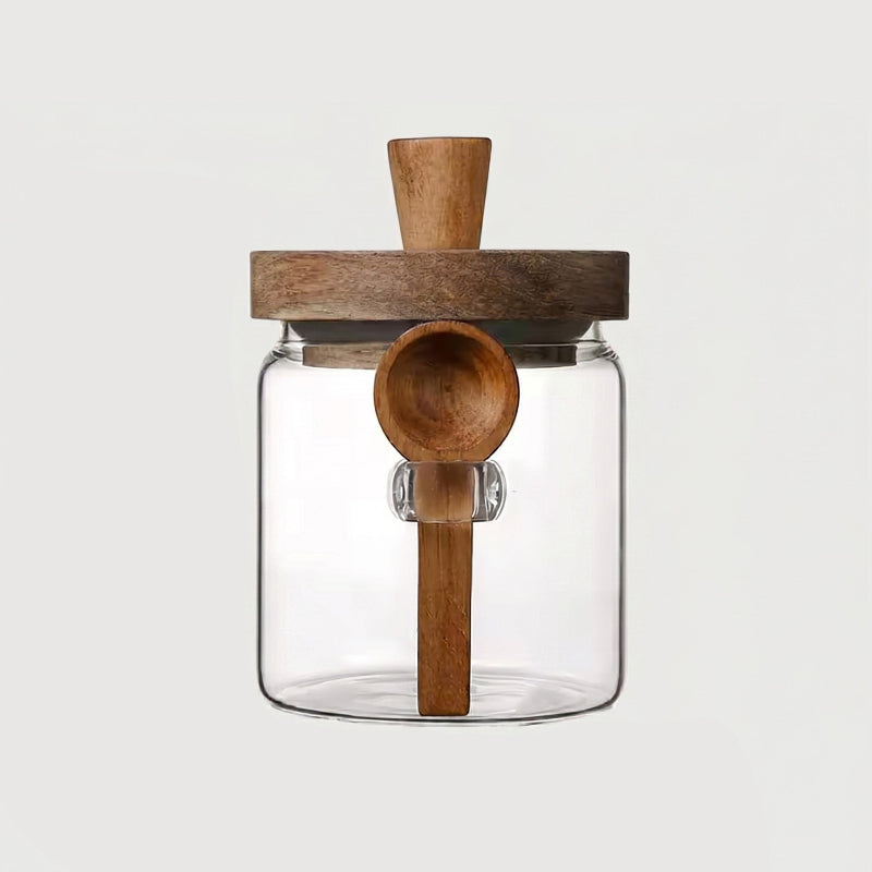 Single airtight glass jar with acacia lid and spoon on white background