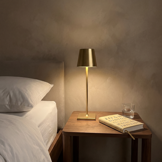 Allegra dimmable cordless table lamp on bedside table in softly lit bedroom