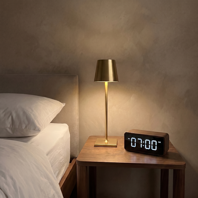 Allegra dimmable cordless table lamp on bedside table beside digital clock