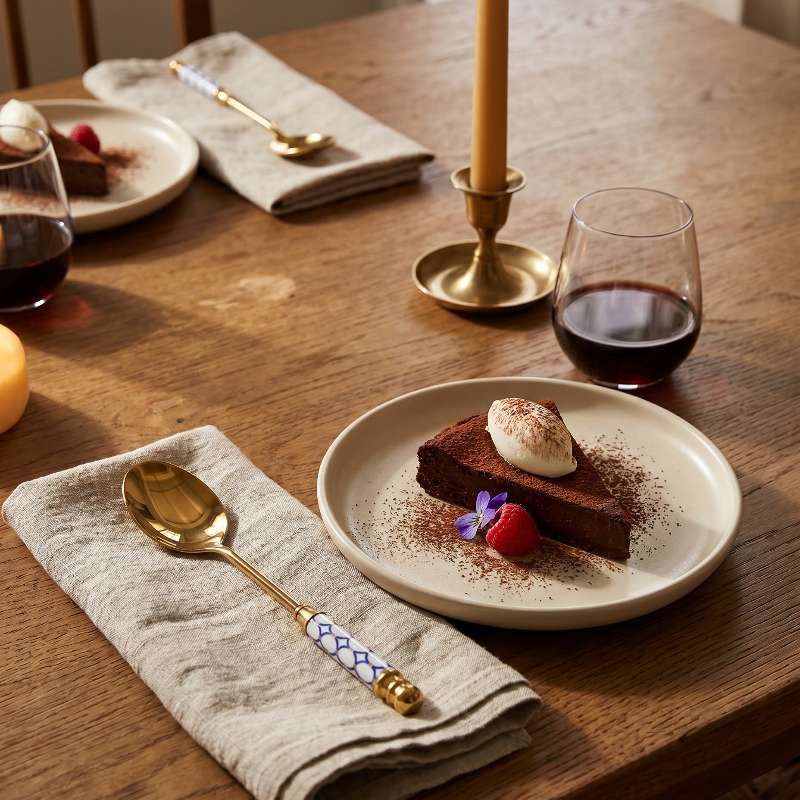 Amalfi dessert spoons on dining table with candle and dessert plate