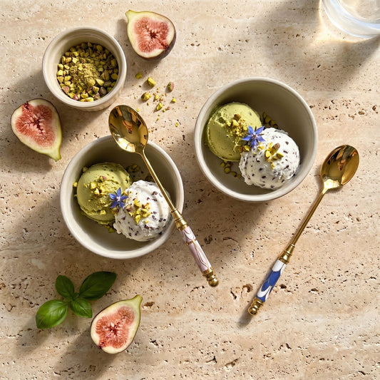 Amalfi dessert spoons beside pistachio dessert bowls on stone surface