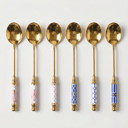 Set of Amalfi dessert spoons in assorted handle designs on white background
