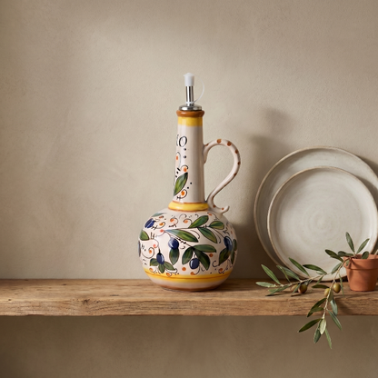 Amalfi olive oil bottle on shelf beside plates in warm natural light