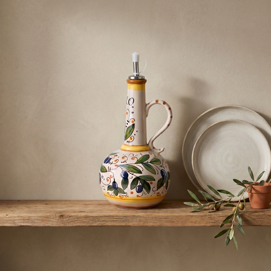 Amalfi olive oil bottle on shelf beside plates in warm natural light
