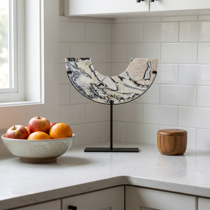 Arched Marble Sculptural Object on a kitchen counter beside a bowl of fruit