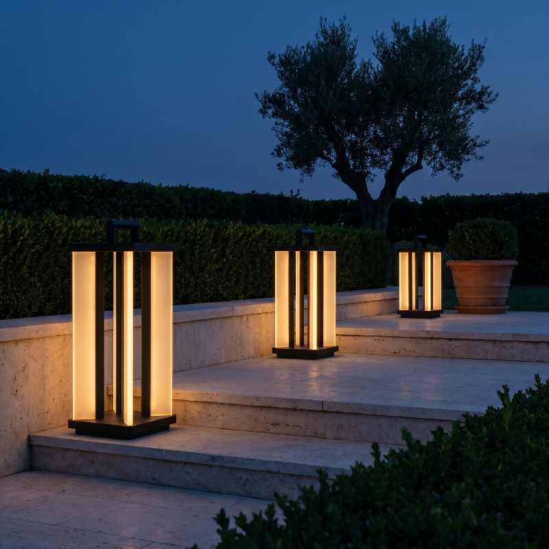 Architectural outdoor solar lanterns on stone patio at dusk