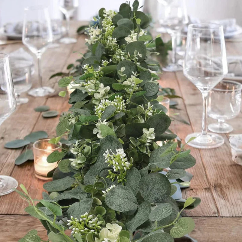 Artificial eucalyptus garlands used as natural, nature inspired table runner for an outdoor dinner party.