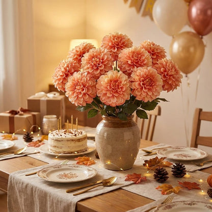 Peach dahlia bouquet in a vase beside a birthday cake and gifts