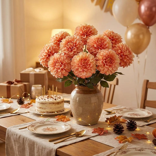 Peach dahlia bouquet in a vase beside a birthday cake and gifts