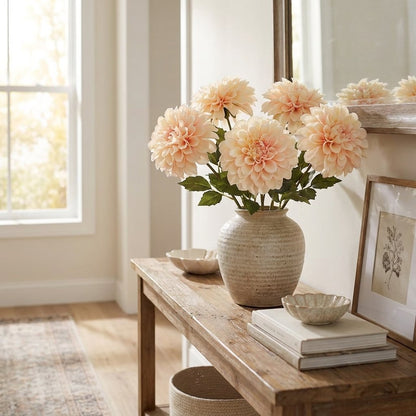 Champagne dahlia bouquet in a stoneware vase on an entryway console table