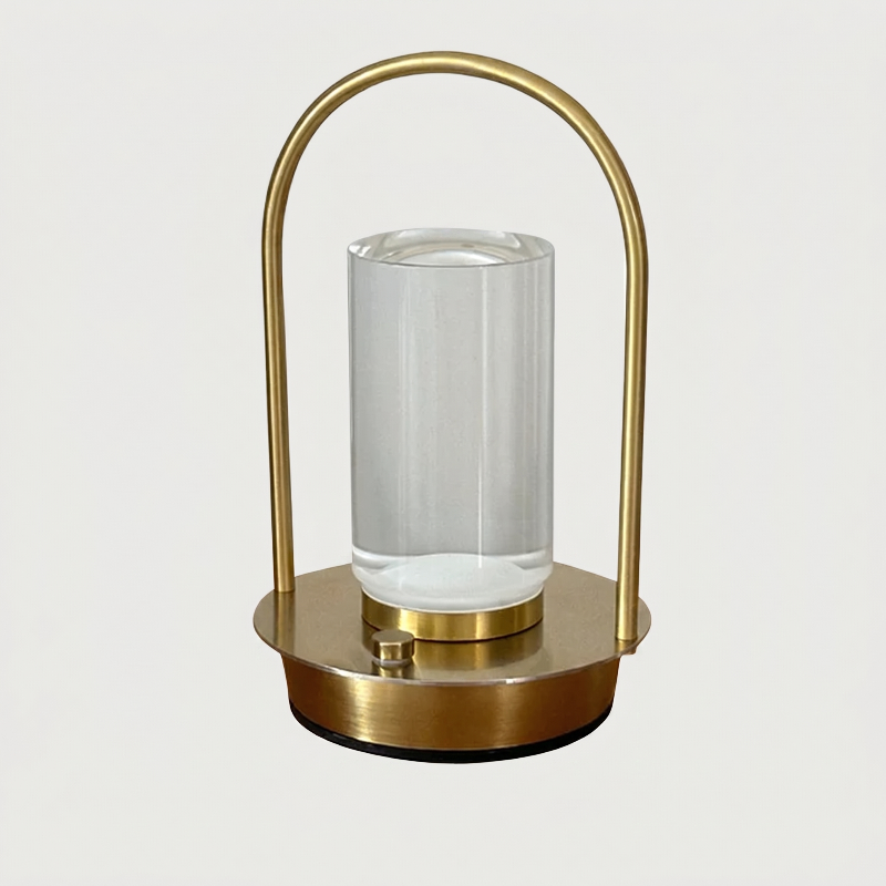 Aura portable crystal table lamp in gold on white background