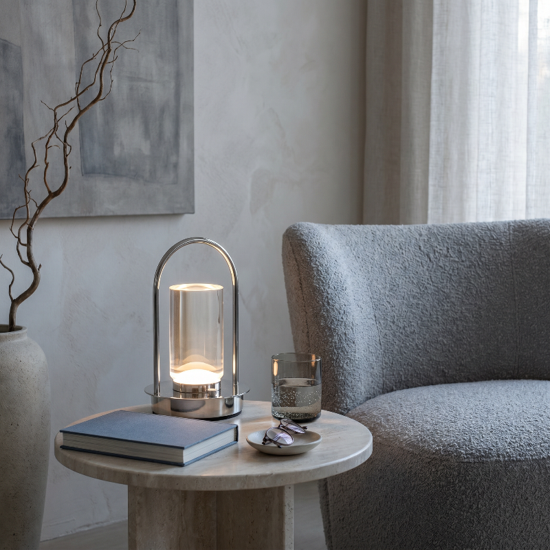 Aura portable crystal table lamp in silver on side table in neutral bedroom