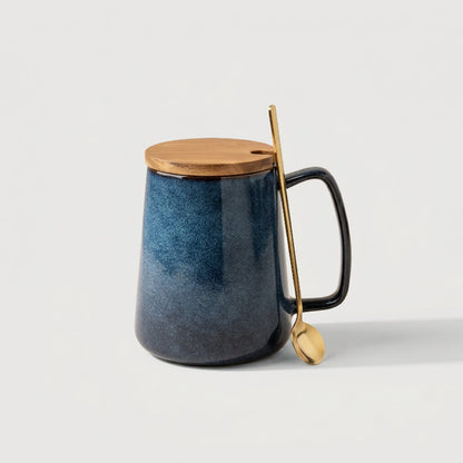Azure blue pottery mug on white background with wooden stir stick