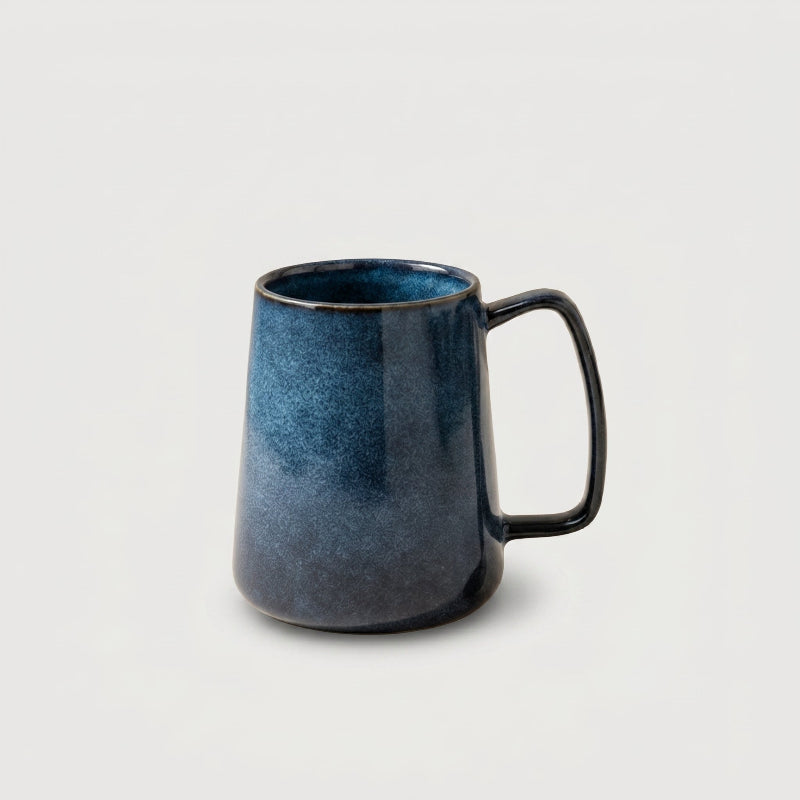 Azure blue pottery mug on white background side view