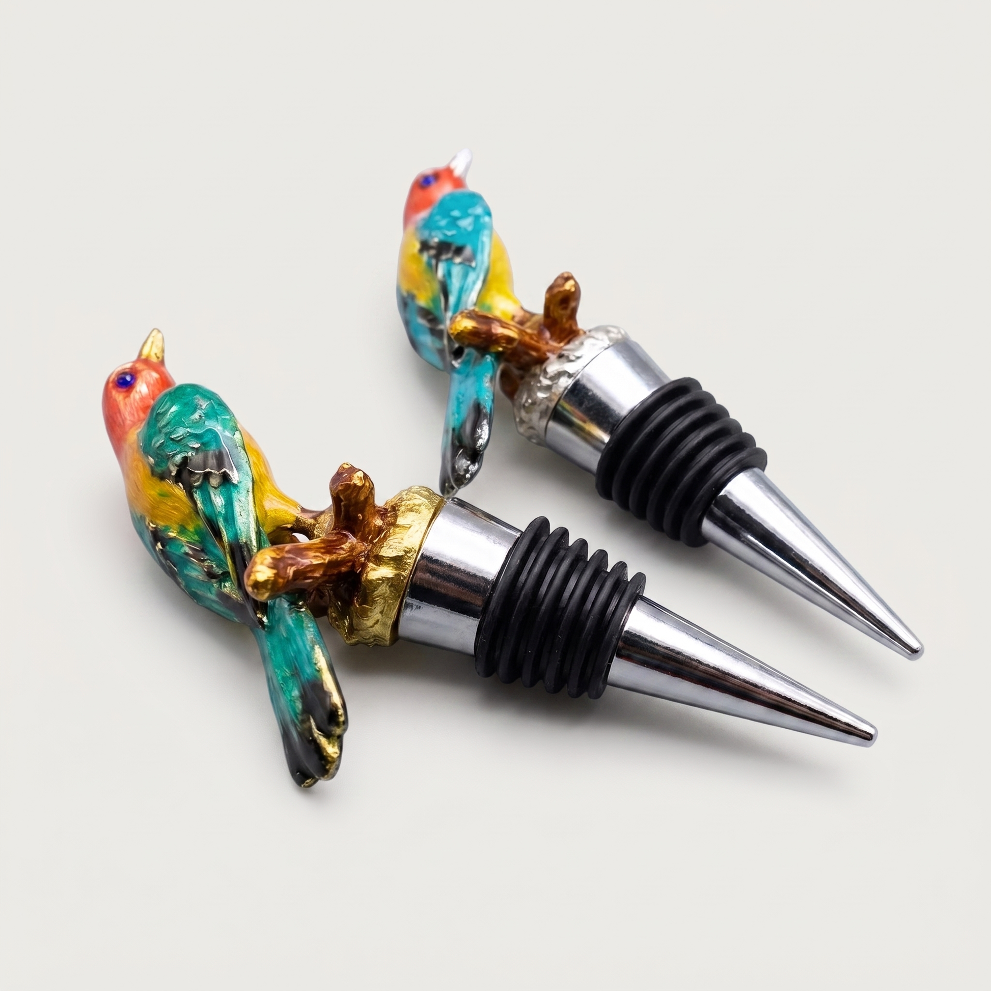Kingfisher and magpie enamel bird wine bottle stoppers shown together on a clean off-white background