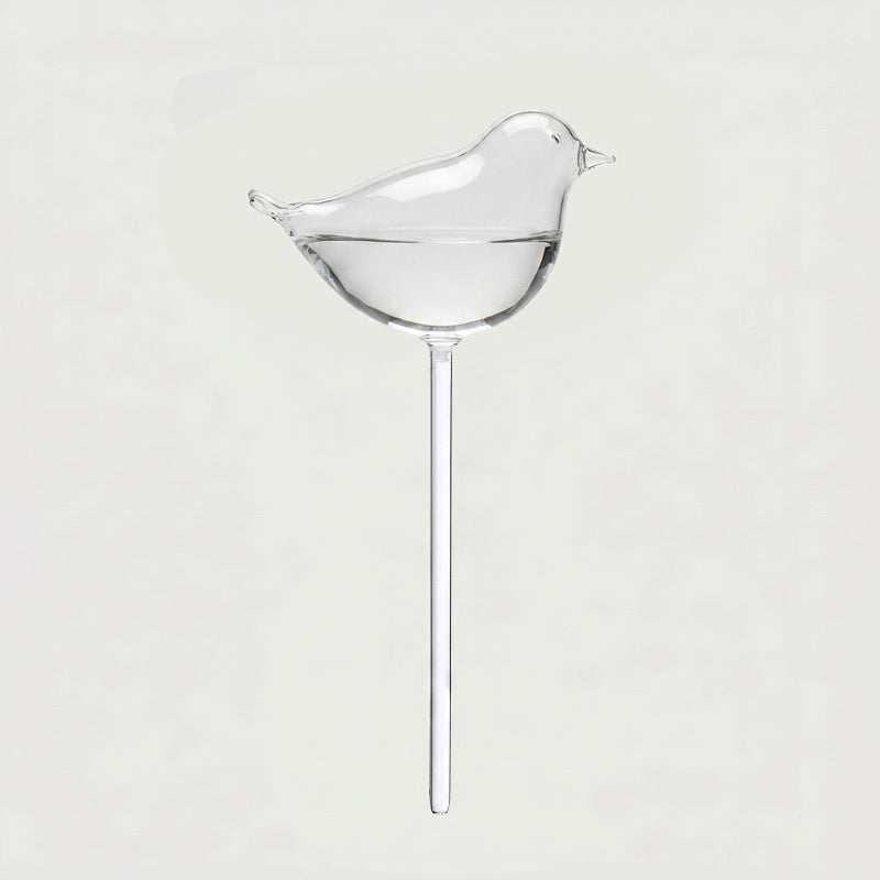 Bird self-watering glass plant vessel on white background