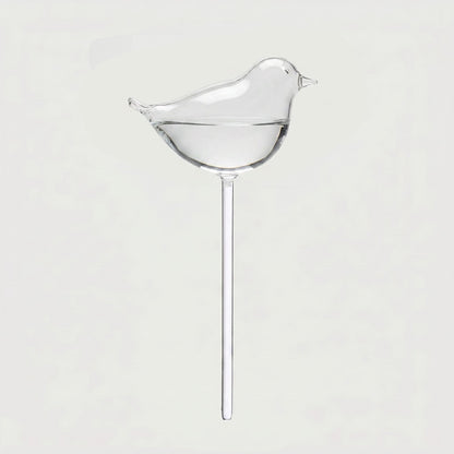 Bird self-watering glass plant vessel on white background