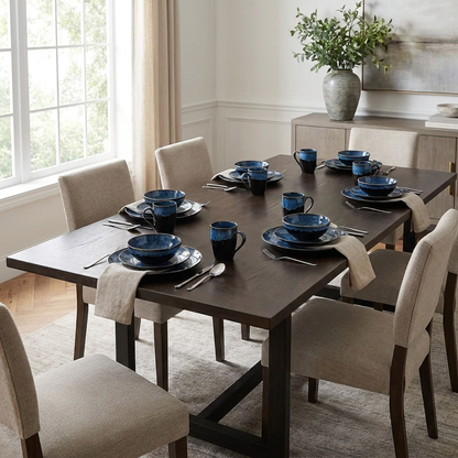 Black and blue glazed ceramic dinnerware set on a table in a modern dining room