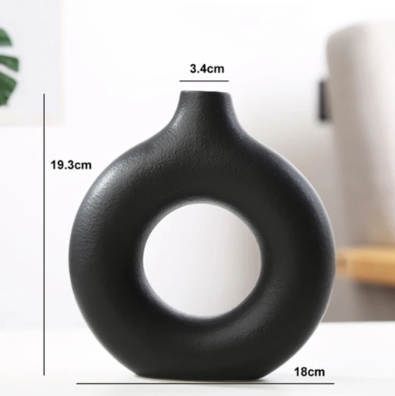 Modern circular vase with a simple yet stylish design, perfect for any floral arrangement.