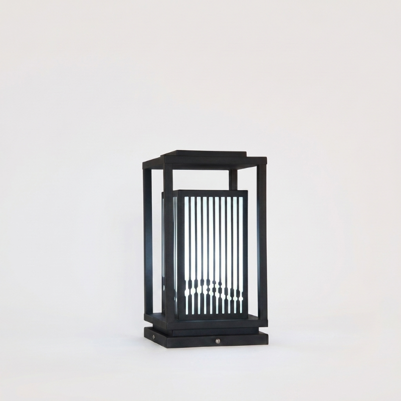 Black outdoor lantern with glass panels on a white background