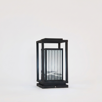 Black outdoor lantern with glass panels on a white background