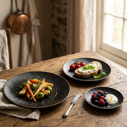 Black ribbed ceramic plates with gold rims holding a roasted vegetable dish