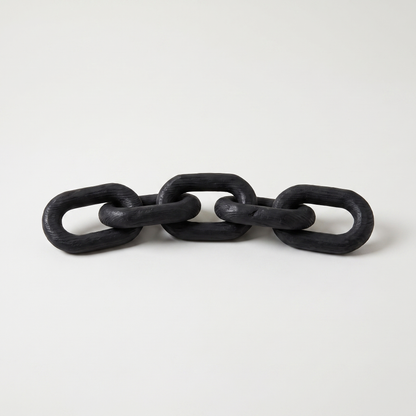 Black wooden decorative chain with five hand-carved links and a matte black finish on a clean off-white background