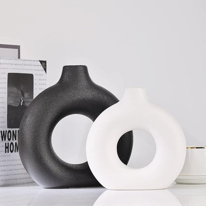 Sleek circular vase with a modern design, ideal for adding a chic touch to any room.